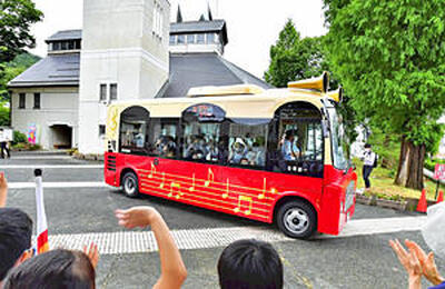 運行を開始した古関裕而メロディーバス＝１日午前、福島市・古関裕而記念館前広場
