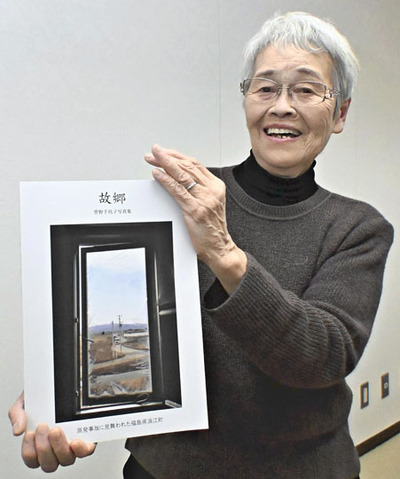 震災後の浪江の日常をカメラで収めた写真集を手にする管野さん