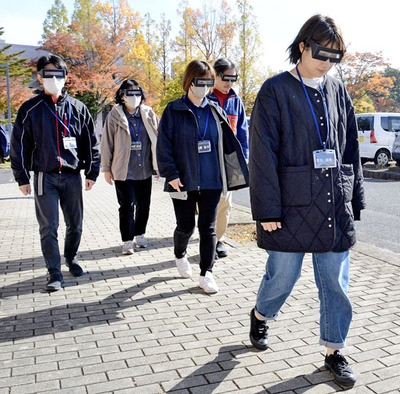 視覚狭窄などを疑似体験できる眼鏡を使って屋外を歩行する参加者