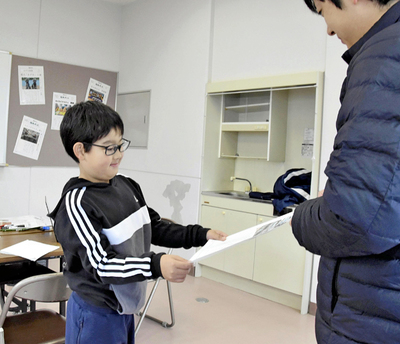 製作した新聞を受け取る参加者