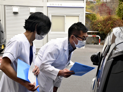 発熱外来を受診した患者に検査結果を伝える新村院長（右）ら病院スタッフ＝いわき市・常磐病院