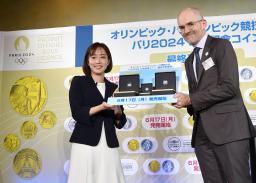 　パリ五輪・パラリンピックの公式記念コインを贈呈される石川佳純さん（左）＝１２日午後、東京都港区