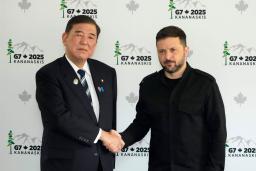 　会談前に握手するウクライナのゼレンスキー大統領（右）と石破首相＝１７日、カナダ西部カナナスキス（共同）